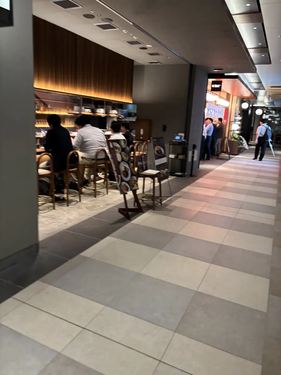 Narrow restaurant corridor with counter seating inside TOFROM YAESU