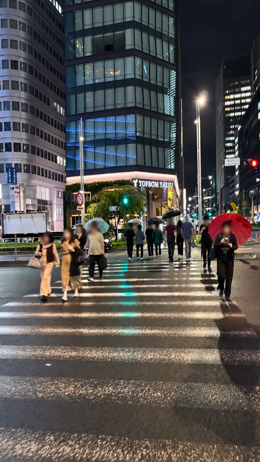 Pedestrian crossing leading toward the illuminated TOFROM YAESU building at night